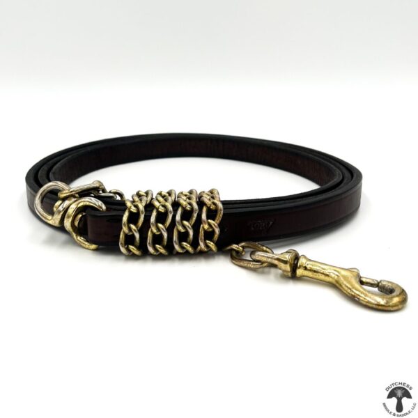 A leather dog leash with gold chain detailing.