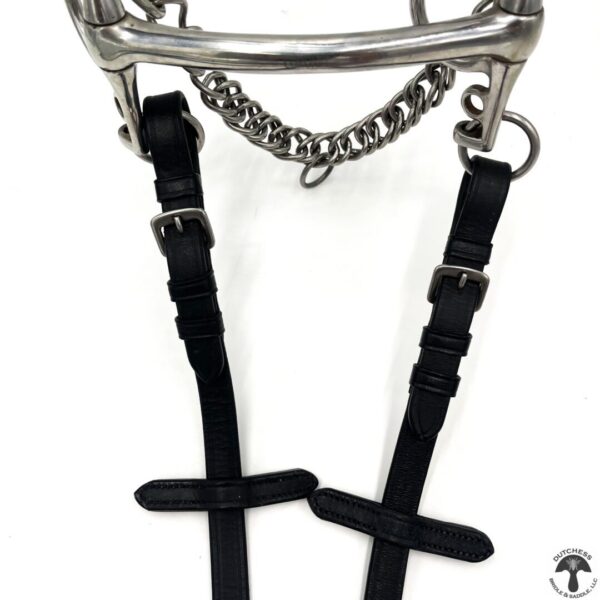 A pair of black leather horse bit with chains.