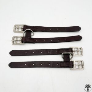 A set of four leather straps with metal buckles.