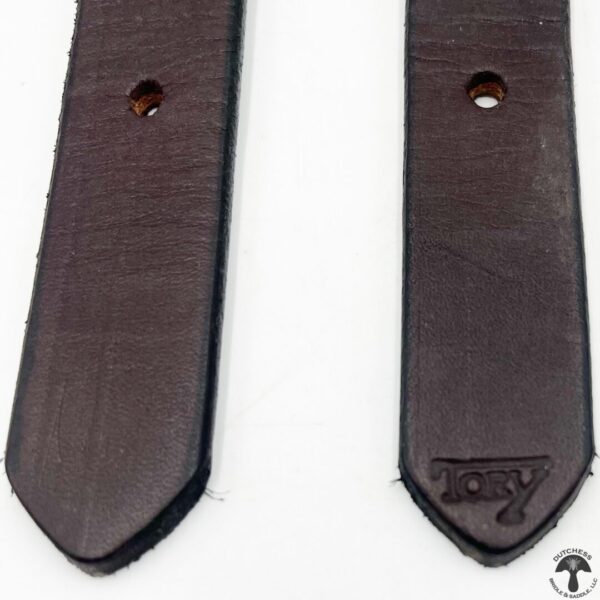 A pair of brown leather straps with a logo on them.