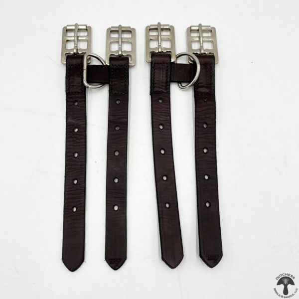 A pair of brown leather dog collars with metal buckles.