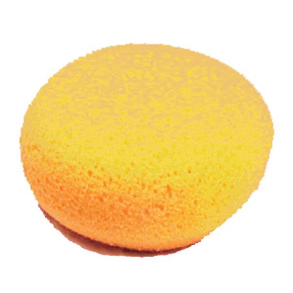 A yellow sponge is sitting on top of the floor.