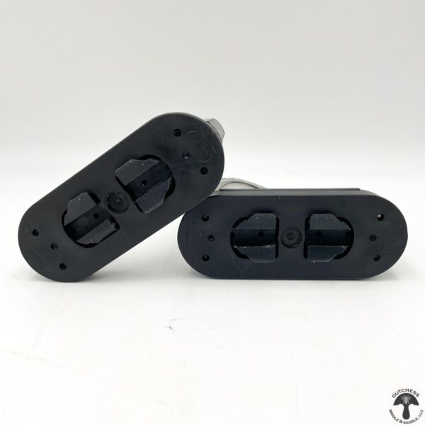 A pair of black plastic car door handles.