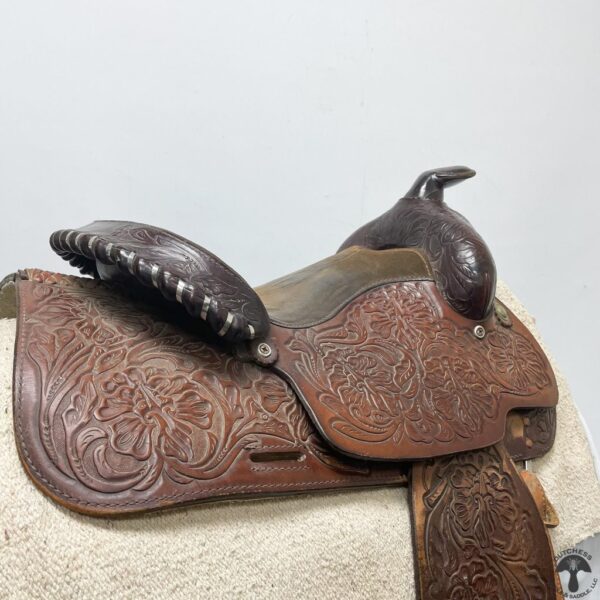 A saddle that is sitting on top of a white surface.