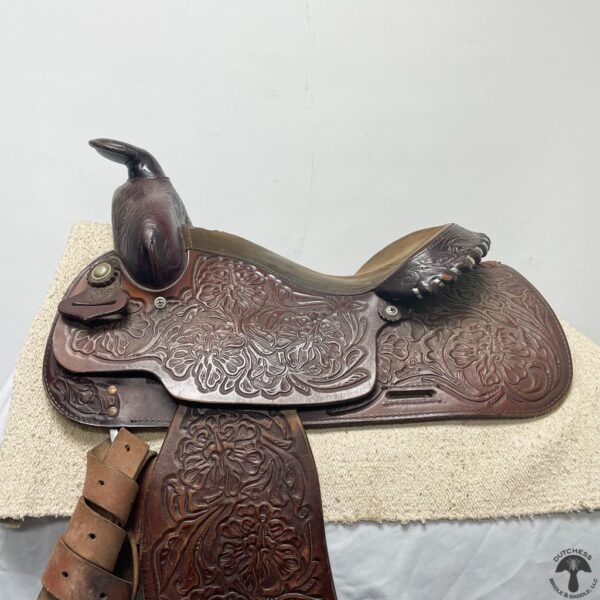 A close up of the saddle on a horse