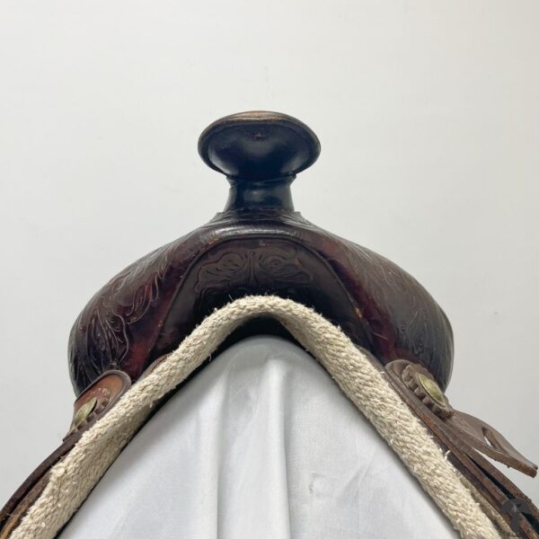 A close up of the saddle on a horse