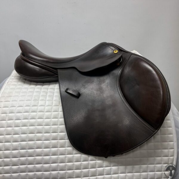 A saddle is sitting on top of the white surface.