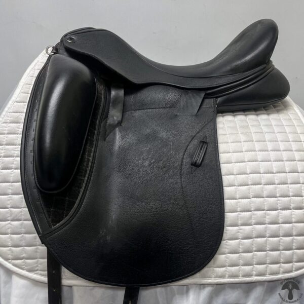 A black saddle sitting on top of a white horse.