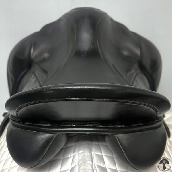 A close up of the seat on a black saddle