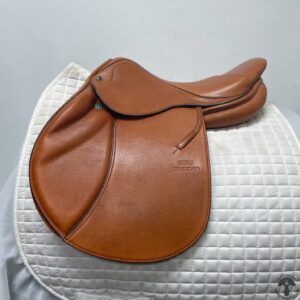 A saddle is sitting on top of the white cover.