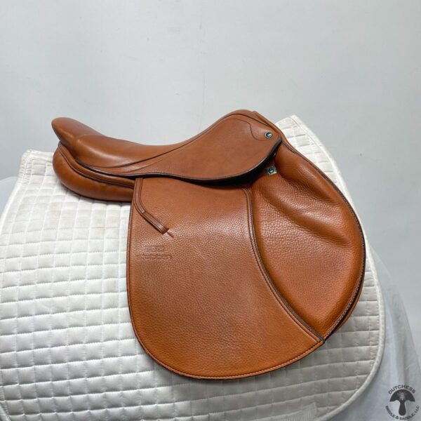 A saddle sitting on top of a white cushion.