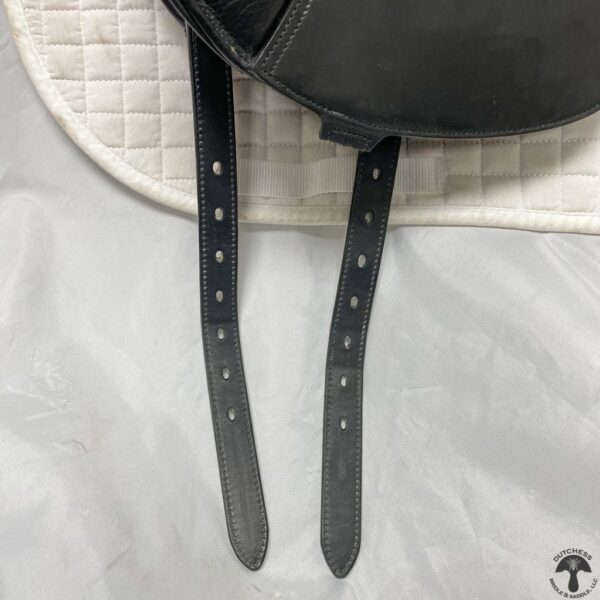 A close up of the straps on a black purse