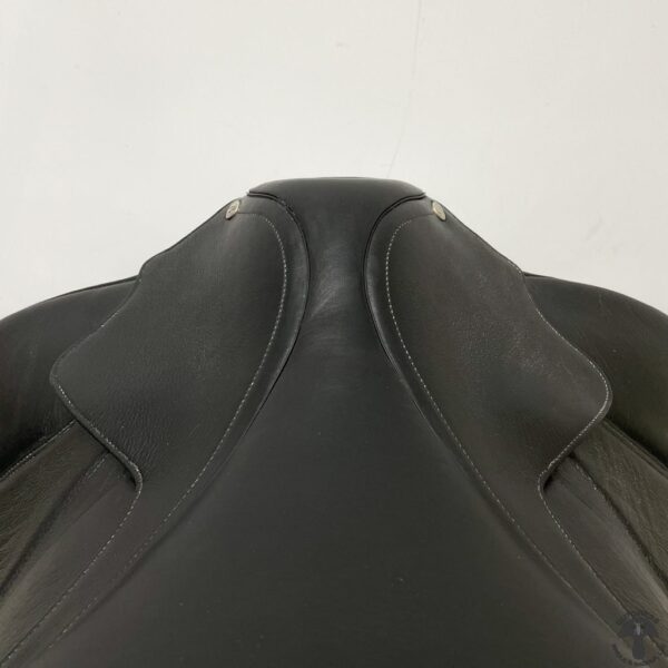 A close up of the back end of a horse saddle.