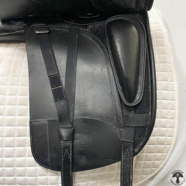 A black saddle bag on top of a white mat.