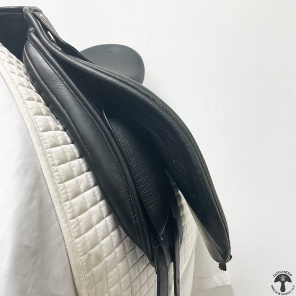 A close up of the saddle cover on a horse.