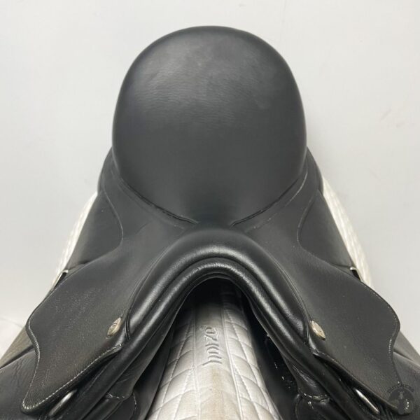 A close up of the seat on a black saddle