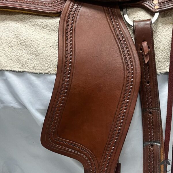 A close up of the leather on a horse 's saddle.