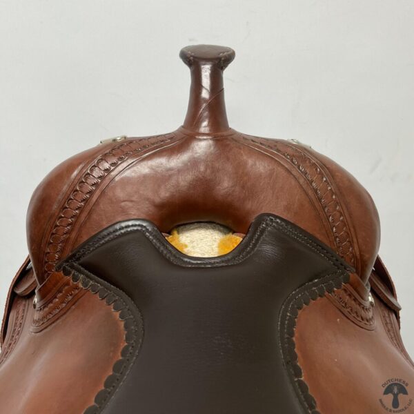 A close up of the saddle with the bell on.