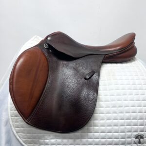 A saddle sitting on top of a white pad.