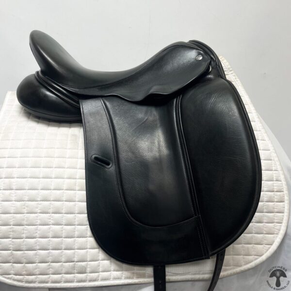 A black saddle sitting on top of a white pad.