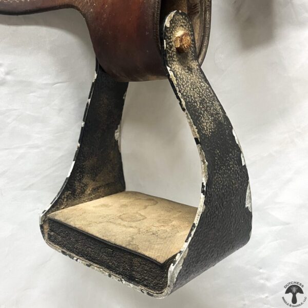 A close up of the bottom part of a horse 's stirrups.