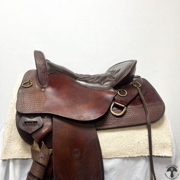 A saddle on top of a blanket.