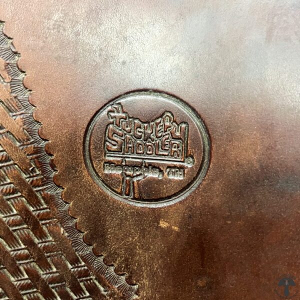 A close up of the stamp on a metal object.