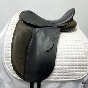 A close up of the saddle on a white horse.