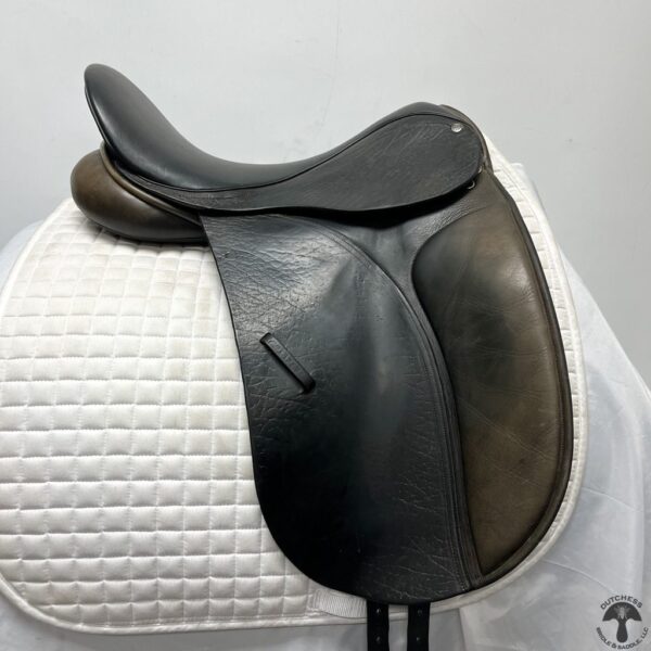 A close up of the saddle on a white horse.