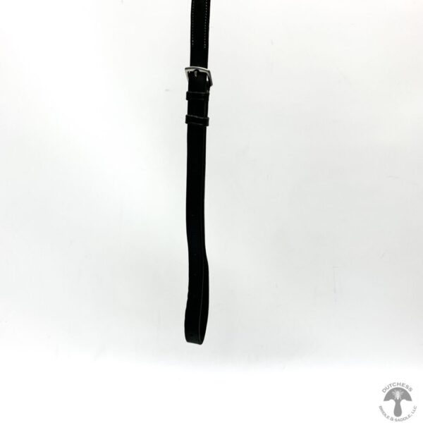 A black leather strap hanging from the side of a wall.