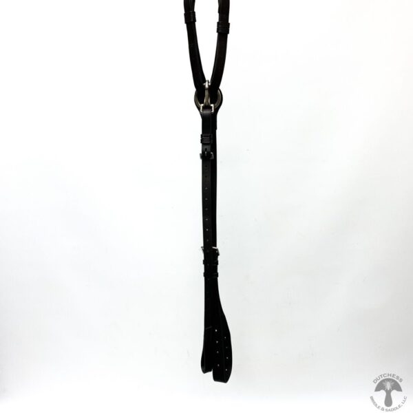 A black leather strap hanging from the side of a white wall.