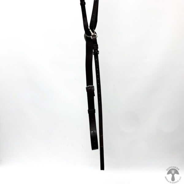 A black leather strap hanging from the side of a white wall.