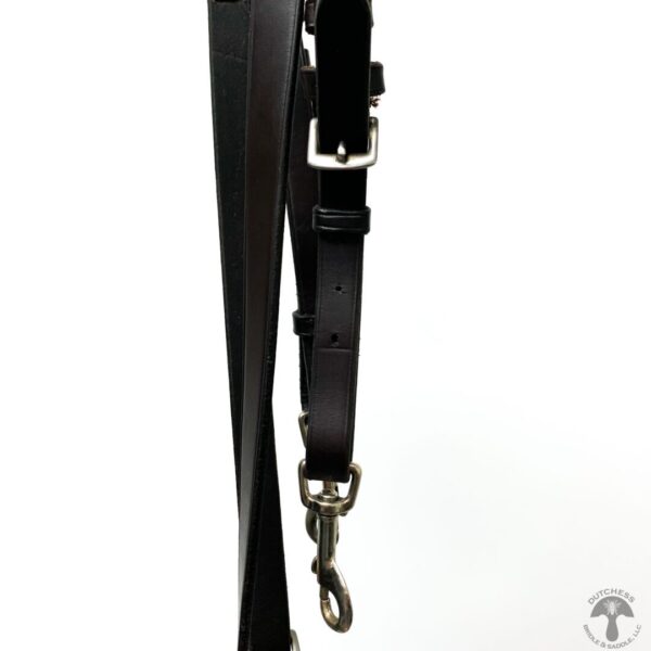 A black leather strap hanging on the wall.