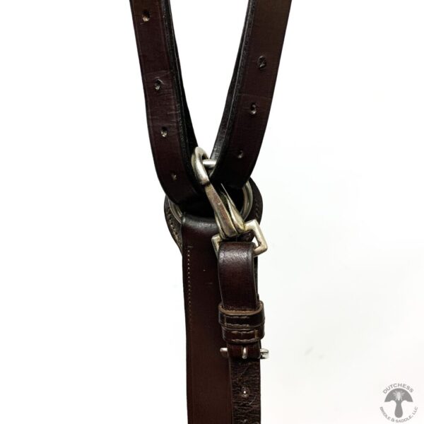 A close up of the leather strap on a horse.