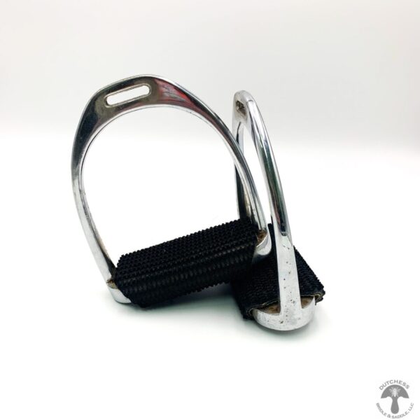 A pair of metal stirrups sitting on top of a table.