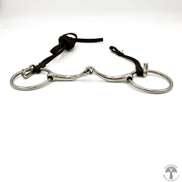 A pair of metal horse bit with leather strap.