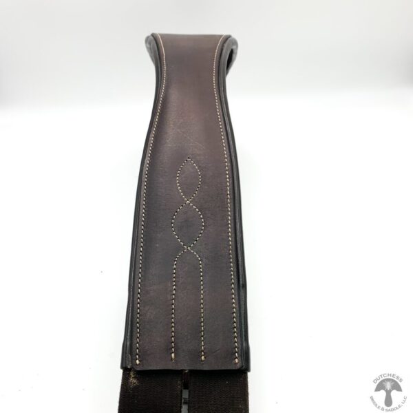 A brown leather strap with a white design on it.