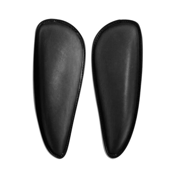 A pair of black leather pads for shoes.