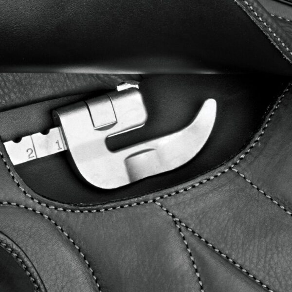 A wrench in the pocket of a leather bag.