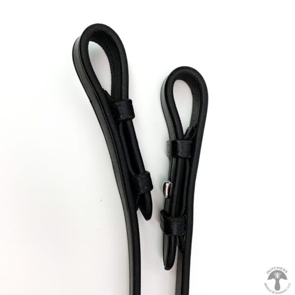 A pair of black leather straps on a white background.