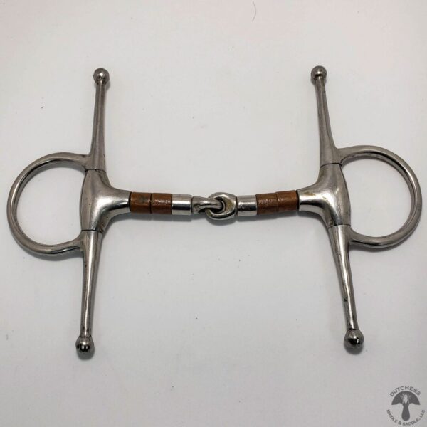 A pair of metal horse bits with wooden handles.