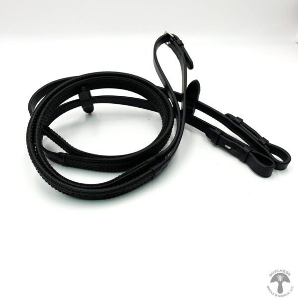 A pair of black leather reins on top of a white table.