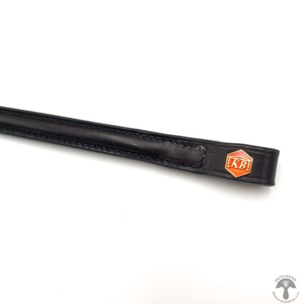 A close up of the side of a black and orange pen