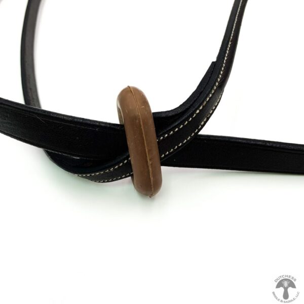 A wooden bead is attached to the end of a leather strap.