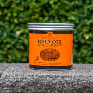 A can of belvoir is sitting on the ground.