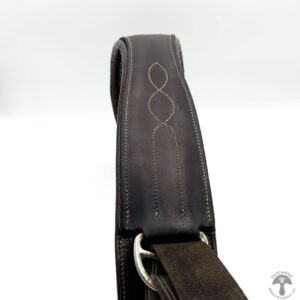 A close up of the strap on a brown leather bag