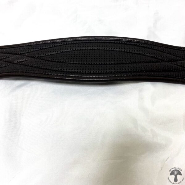 A black belt is shown on top of a white sheet.