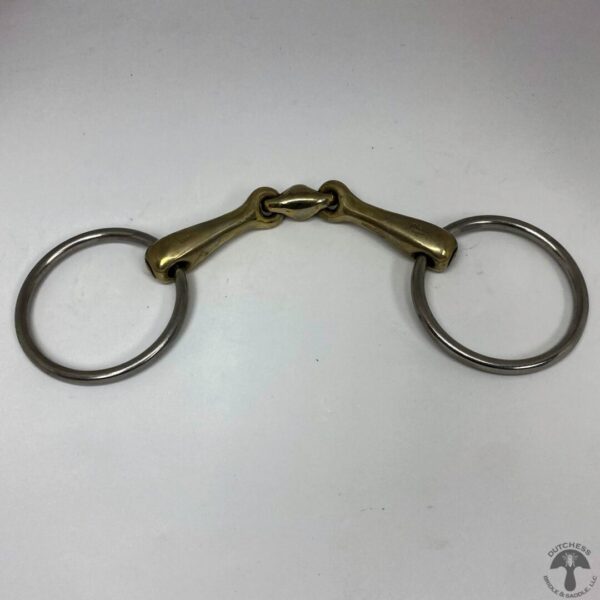 A pair of metal horse bit with two rings.