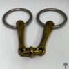 A pair of metal horse bit with two rings.