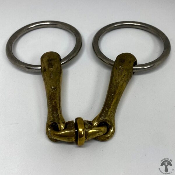 A pair of metal horse bit with two rings.